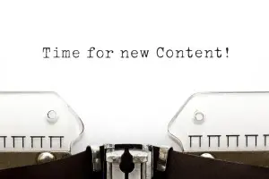 Words "Time for new content!" on a typewriter